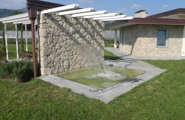 New villa with pool and large garden near the beach.