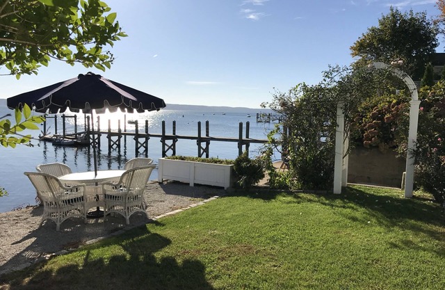 Old fashioned designer front porch living by the sea with expansive water views.