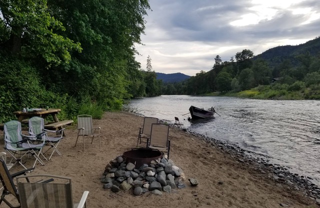 RIVER LIFE ON A WARM SANDY BEACH ON THE RIVER NEXT TO DOWNTOWN ROGUE RIVER.
