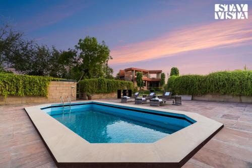 StayVista at The Cityscape with Lawn & Pool