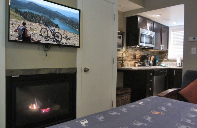 Studio with larger kitchenette, fireplace, and nearby attractions