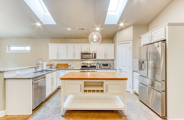 Two-story, dog-friendly home with central AC, washer/dryer, wood stove, & yard