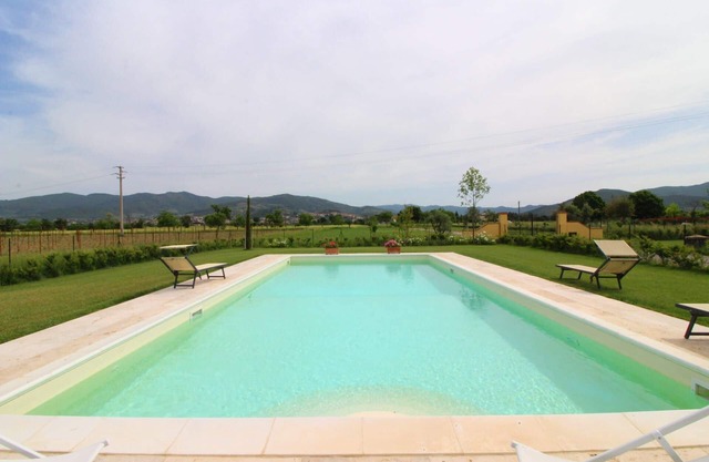 Typical Tuscan house with private and fenced swimming pool. View on the village of Castiglion Fioren