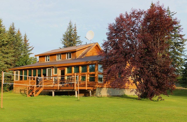 Unique Alaskan log home in trees & wild flowers on 14-acre private homestead.