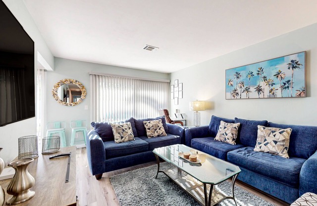 Water-view dog-friendly home with outdoor space & entertainment options