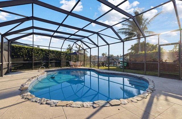 Your Ultimate Coastal Retreat! Stunning 4-Bed Canal-Front Home w/Pool & Lanai