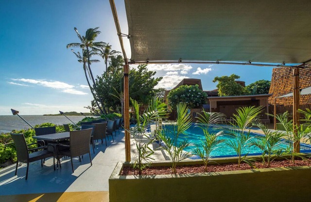 Your Ultimate Oceanfront Retreat | Relaxing Room with Lush Garden View