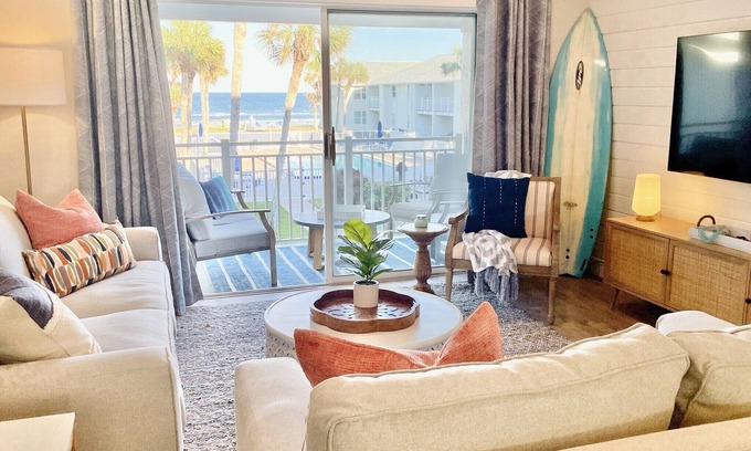New Smyrna Beach Condo | Amazing views of the ocean and pool from this coastal-modern, surfer-chic condo!