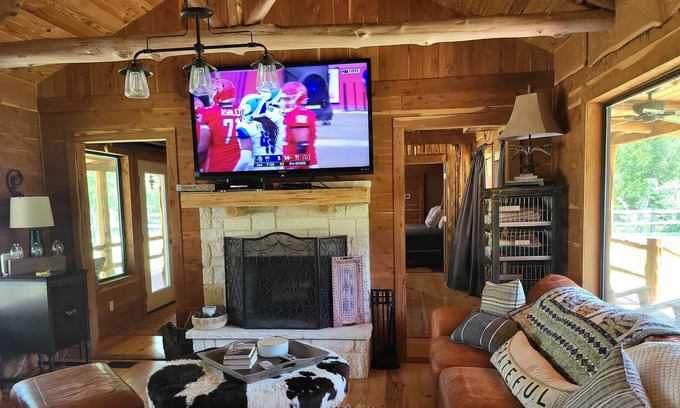 New Ulm Cabin | Cedar Acres offers a 3 Bedroom Log Cabin that overlooks a pond.