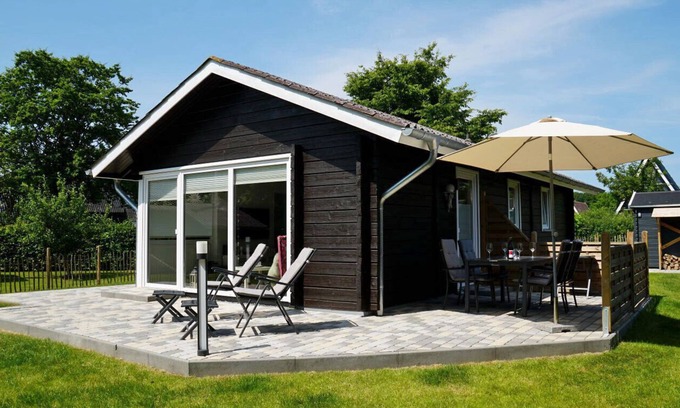 Damp House | Charming wooden cottage "Schmidt's Huus" in Swedish style offers you high-quality furnishings as well as a well-tended garden with a large terrace for a vacation with the whole family or in intimate togetherness