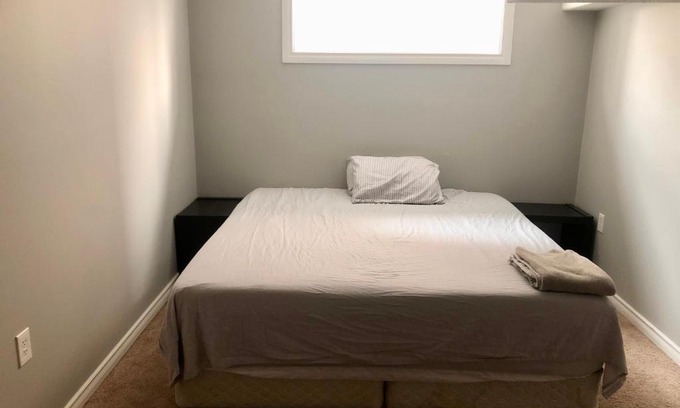 Chestermere House | Chestermere room with King sized bed