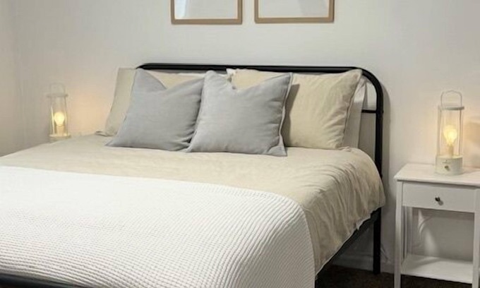 Rock Springs House | Completely Renovated home comfortably accommodates your stay with a queen bed in the primary bedroom, a twin bed with a pull-out trundle in the second bedroom, and a sleeper sofa in the living room for additional guests.