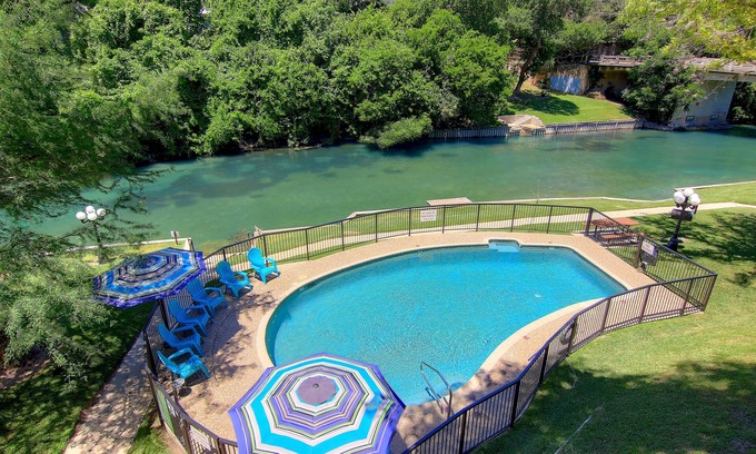 New Braunfels Condo | Immaculate Comal riverfront! Across from Schlitterbahn! Pool & river access!