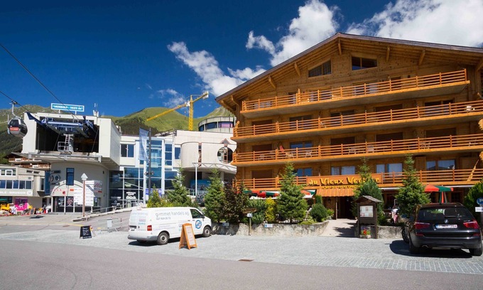Verbier Apartment | Living room with sofa bed, open-plan kitchen with 3 hotplates and Nespresso coffeemachine, small dis