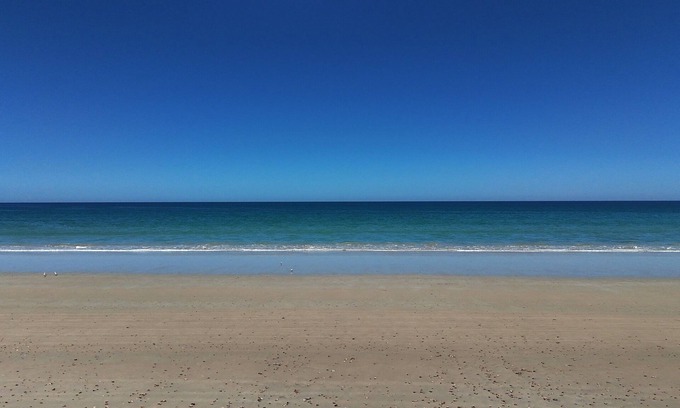 Sellicks Beach House | Ocean views, Sunset on the rear deck, Pet friendly.
