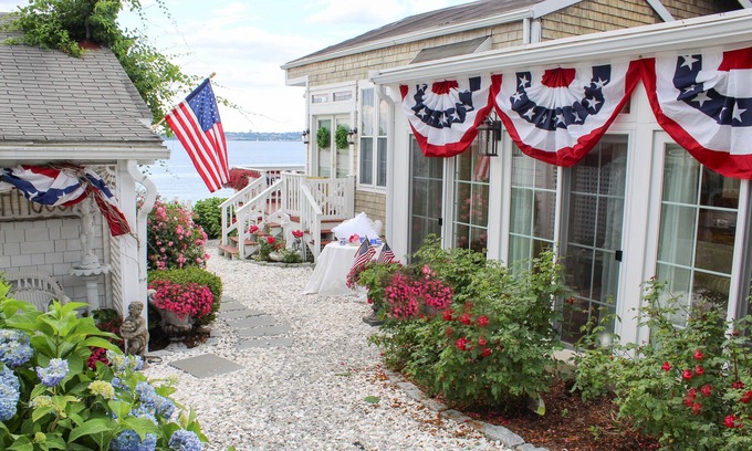 Bristol Cottage | Old fashioned designer front porch living by the sea with expansive water views.