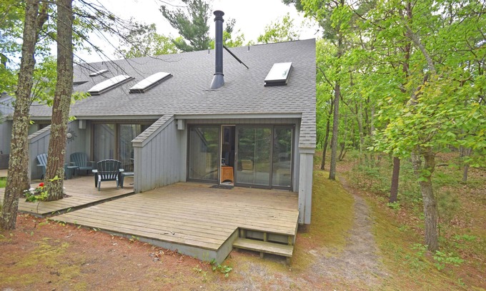 Glen Arbor Condo | Riverfront condo with water views, deck, fireplace, W/D, and community firepit