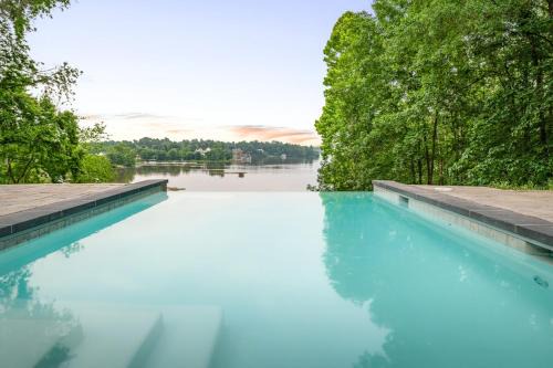 Louisa House | Secluded 3 Acre 5 BR Resort with a Private Heated Salt-Water Pool, Hot tub, Boat Dock, Sauna, and Game Room