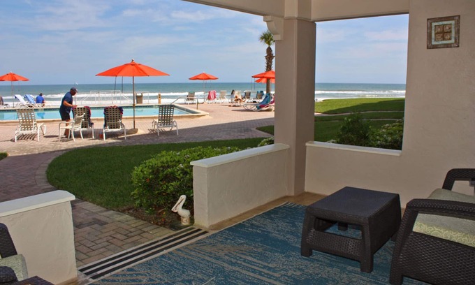 New Smyrna Beach Condo | Steps to south pool deck, pool and ocean from this ground floor, three bedroom, three bath sleeps 8.