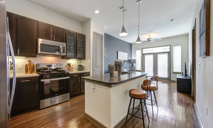 Energy Corridor Apartment | Stunning 1bd suite with warm and bold interiors, great amenities, & a pool view.