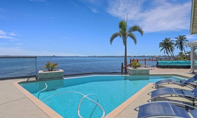 Caloosahatchee House | The River View 1008 - SE Cape Coral Riverfront Luxury Pool Home Pool Table and more