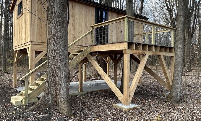 Girard Cabin | Timber framed tree cabin nestled in the woods.