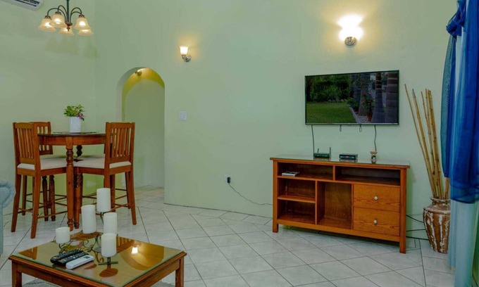 Cades Bay House | Two bedroom, 2 bathroom house in a tropical palm and garden setting.