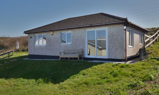Hayle Cottage | Winray is set in a quiet spot on a grassy bank, accessible via several stone steps