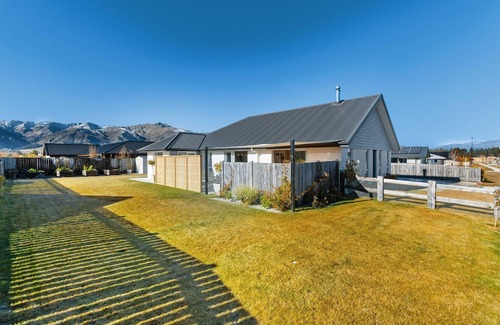 Lake Hawea House | Home nestled in Hawea - A four-bedroom Hawea home with mountain views. Enjoy a modern kitchen, spacious living areas, two bathrooms, and a cosy fireplace