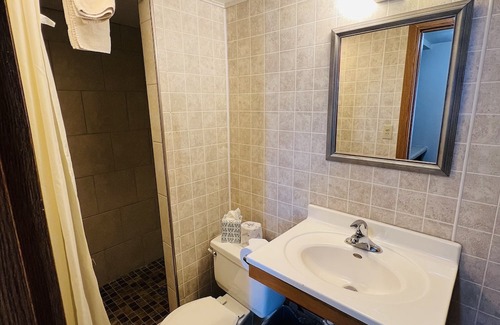 Onalaska House | Overlooking Lake Onalaska -- Queen bed + bathroom in nostalgic motel
