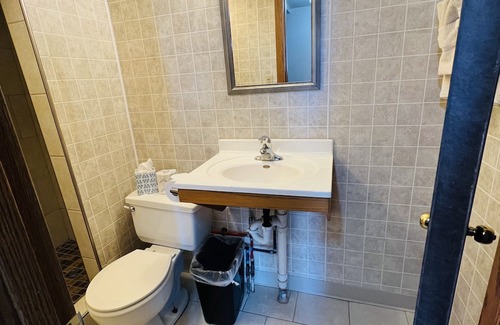 Onalaska House | Overlooking Lake Onalaska -- Queen bed + bathroom in nostalgic motel