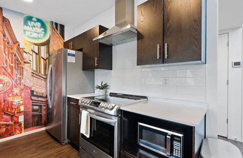 The Gulch Condo | Urban Condominium: Featuring a Pool and Balcony in a Contemporary Mid-Rise