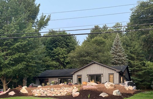 Rapid City House | 50 feet of Torch Lake frontage! Boathouse, beautiful patios sweet little beach.