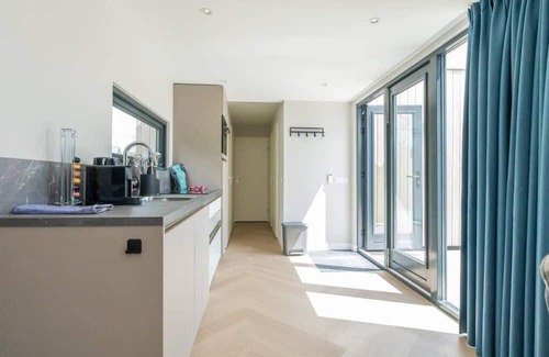 Scharendijke House | Welcome to Muralt 111, a modern chalet with everything for a carefree stay. Enjoy the cozy living ro